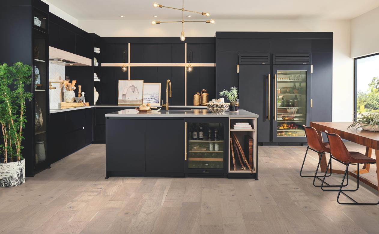 Kiba Studios kitchen display with wood-look flooring at Tudor Floors & More