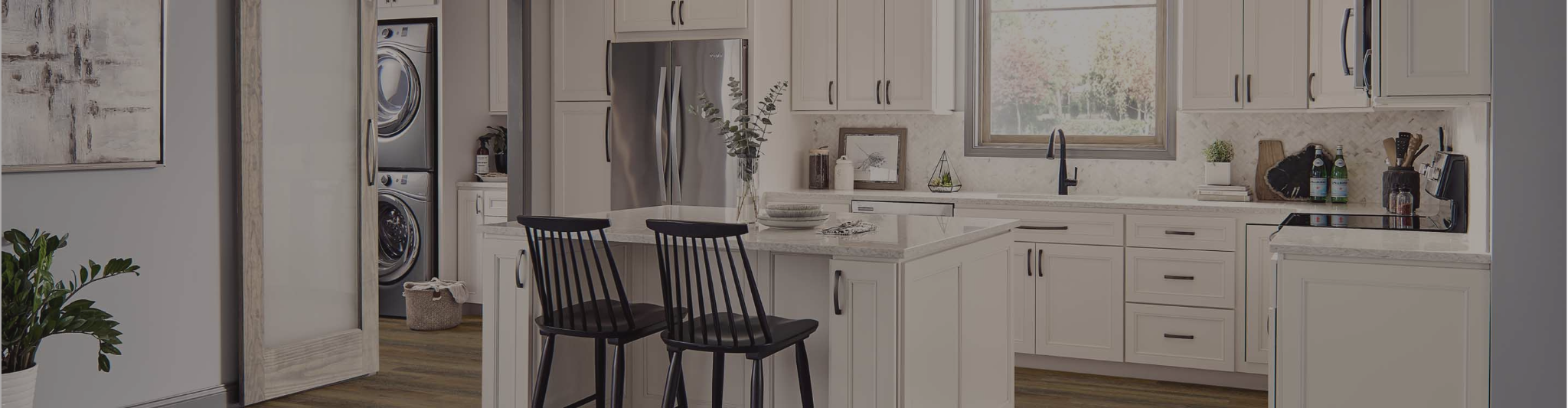Kitchen with wood floors and white cabinetry