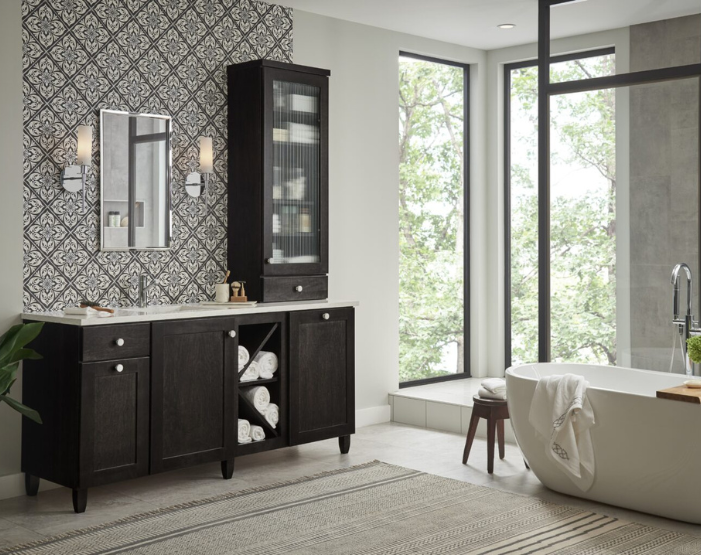 Bathroom with layered lighting, featuring backlit mirrors, recessed ceiling lights, and elegant vanity lighting.